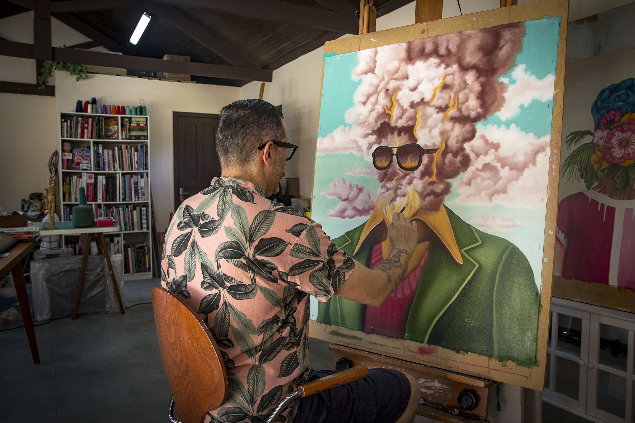 An artist painting in their studio