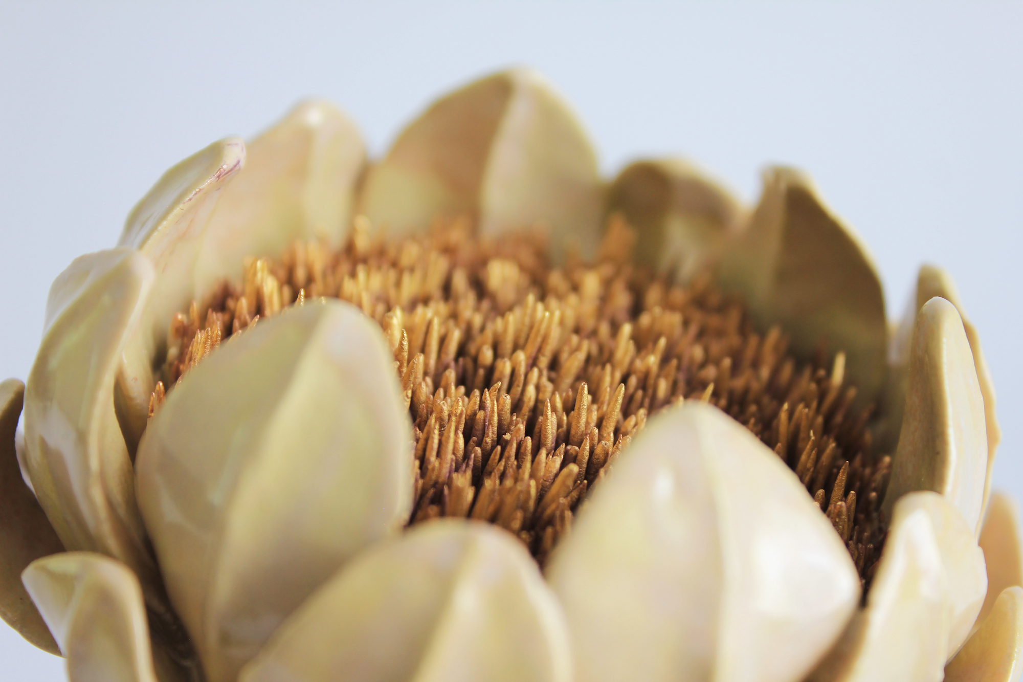 Detail of a yellow ceramic flower.