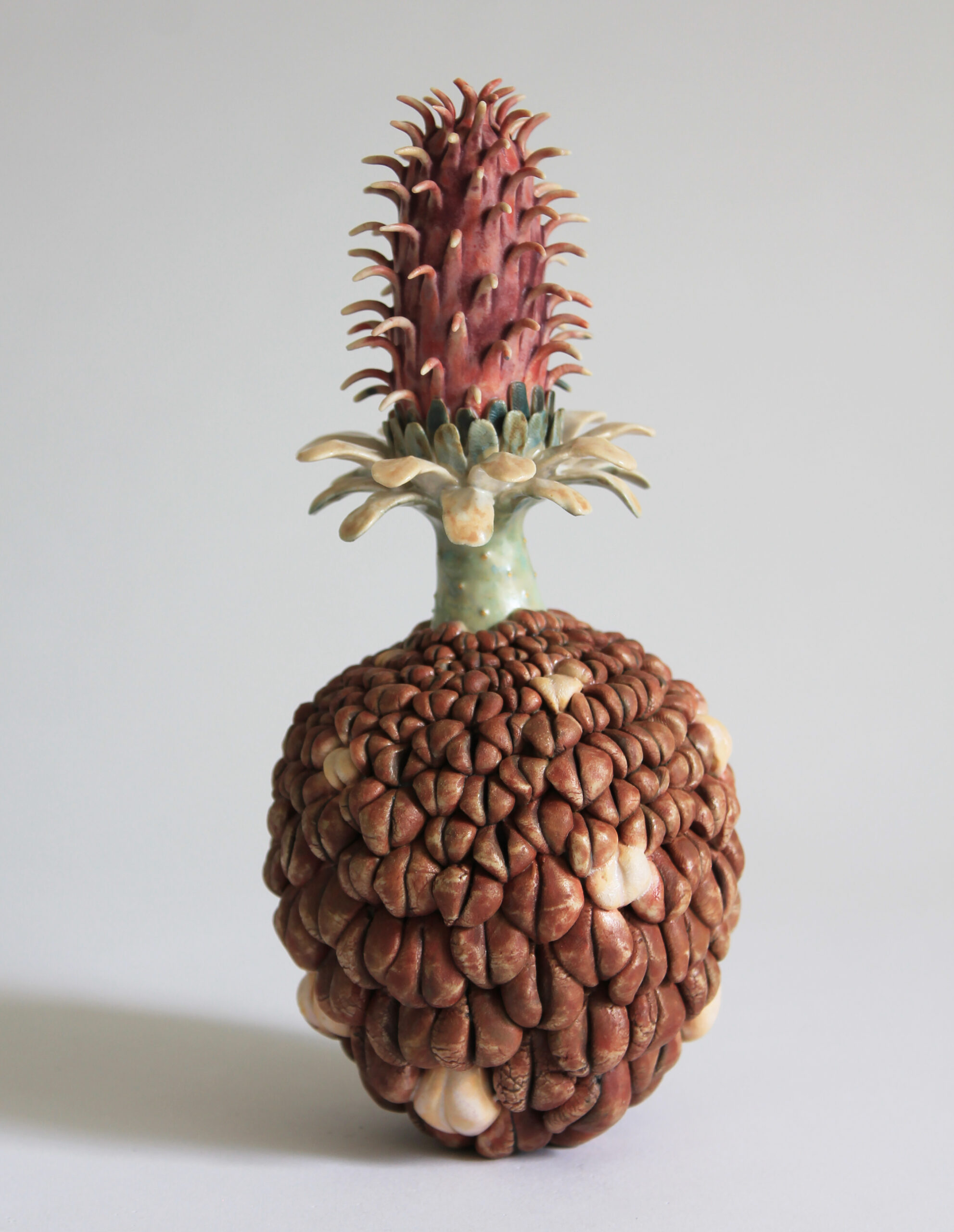 An abstract sculpture of an imaginary plant made from ceramic.