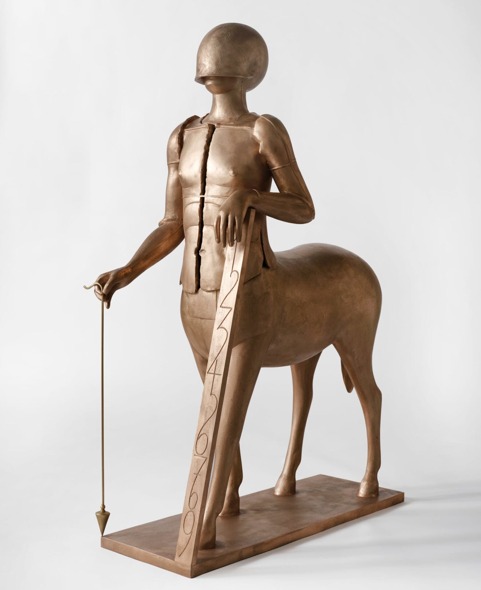 a centaur with a helmet over its face, holding a string with a point that touches the ground and a plane with 1-9