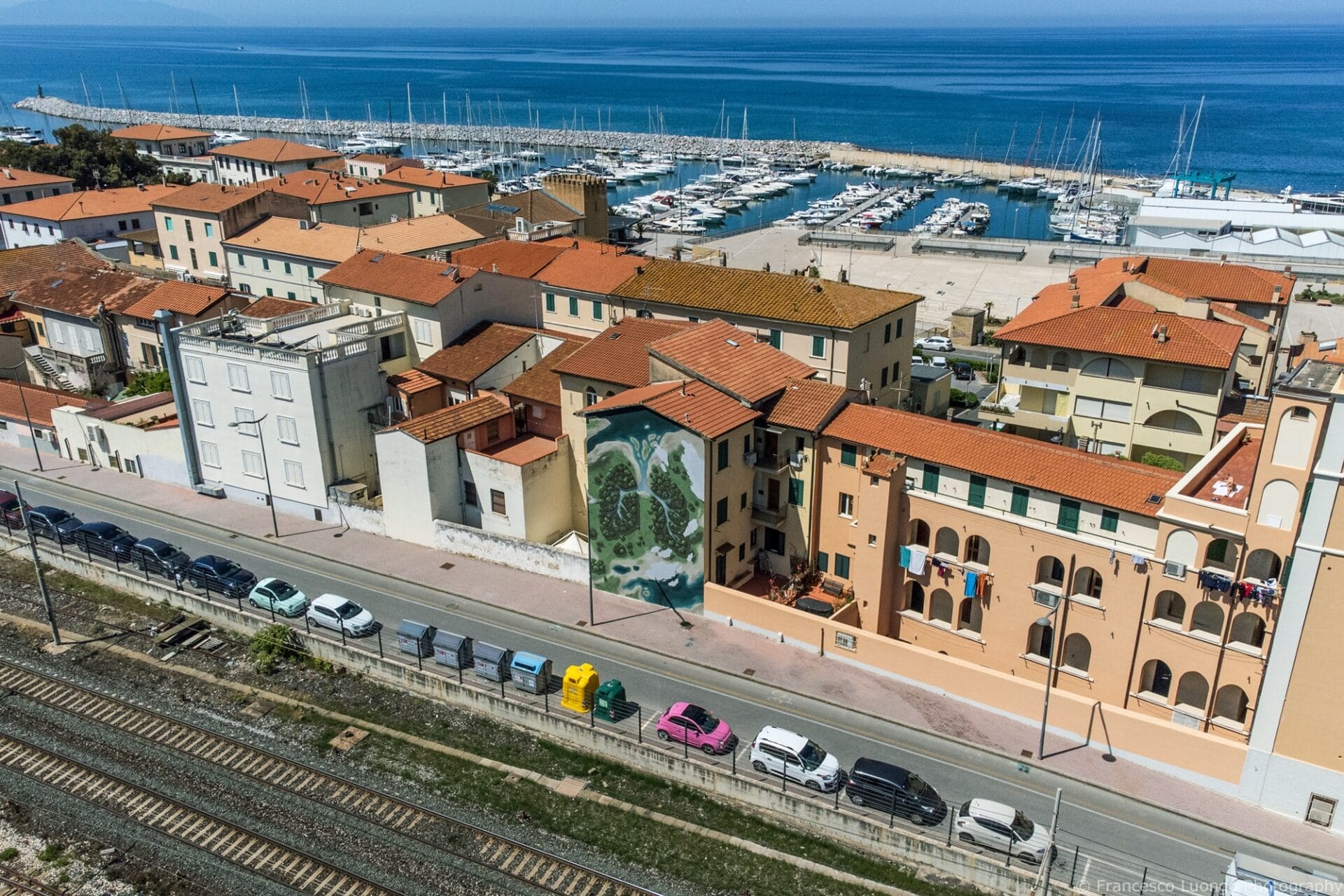 an aerial overview of a mural in an Italian seafront town